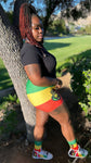 A Rastafari queen embodies strength, spirituality, and cultural pride. She often wears vibrant colors, traditional African patterns, and natural fabrics that reflect her heritage. Her hair is typically styled in dreadlocks or natural curls, symbolizing her connection to her roots. Adorned with jewelry made from natural materials, she radiates confidence and wisdom. The Rasta queen shorts represents love, unity, and a deep respect for the earth and its people.